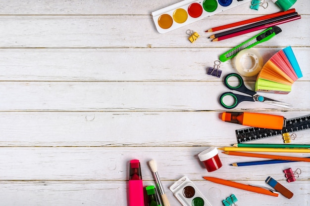 School stationery or office supplies on a wooden wall