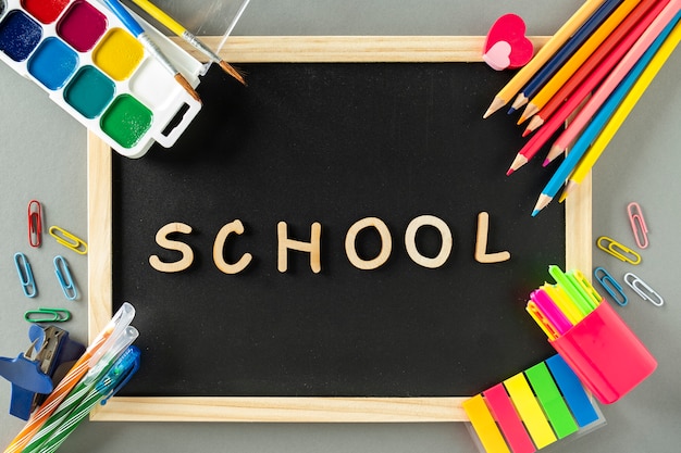 School stationery with word school on a blackboard