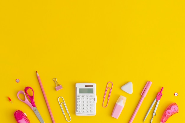 School stationery on a yellow background. Top view with copy space. Flat lay. Back to school concept.