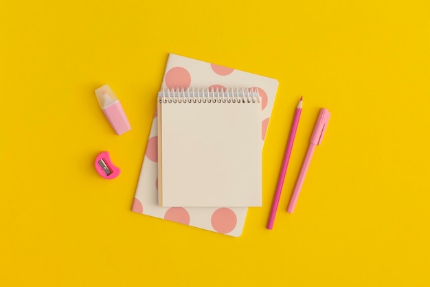 School stationery on a yellow background. Top view with copy space. Flat lay.