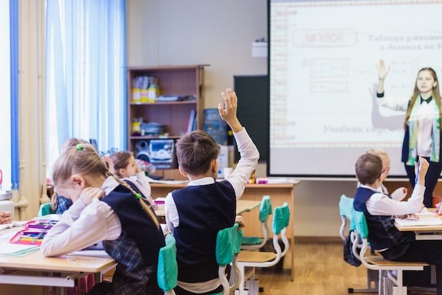 School and students, the child raised his hand to answer the teacher, friendship