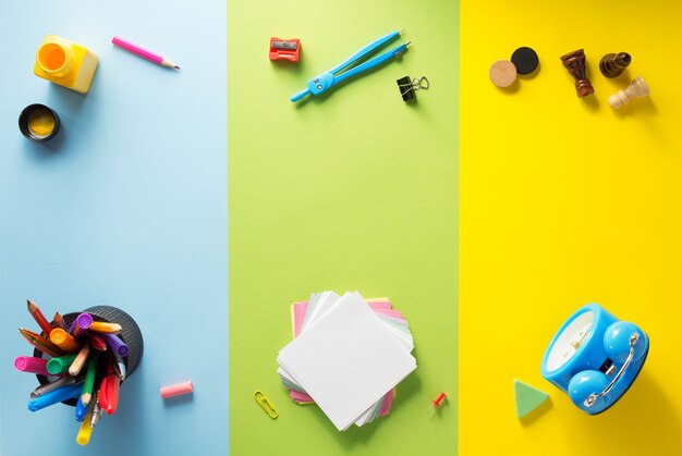 School supplies at abstract colorful background