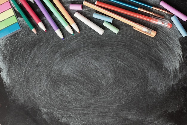 Photo school supplies on blackboard background