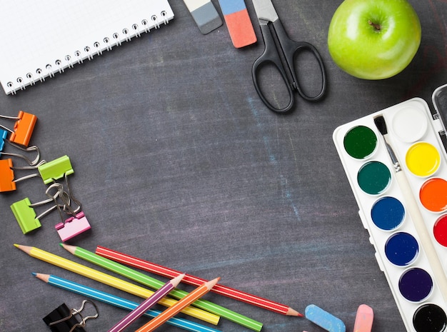 School supplies on blackboard background