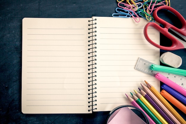 Photo school supplies on blackboard background