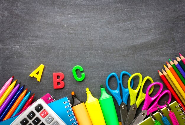 School supplies on blackboard background