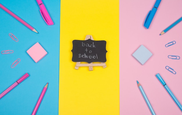 School supplies and a blackboard with Back to School