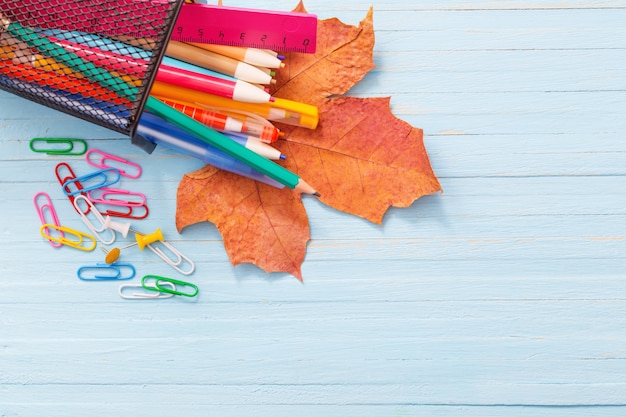 School supplies on  blue wooden background