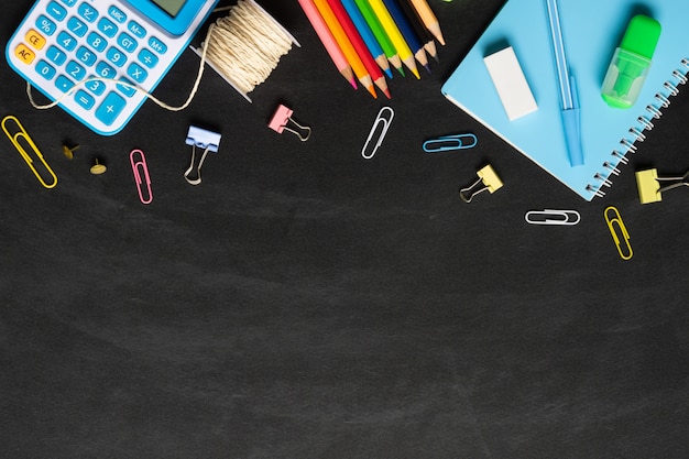 School supplies on a chalkboard 