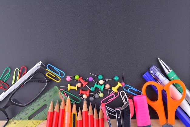 School supplies on chalkboard