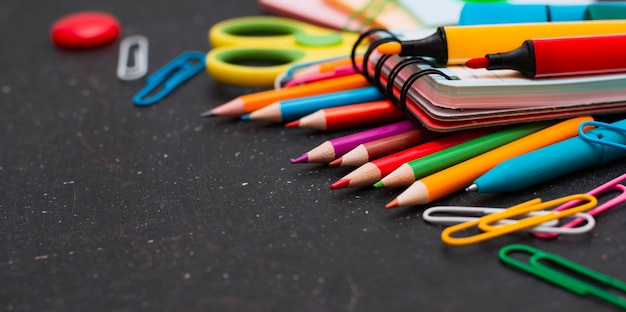 School supplies on chalkboard.