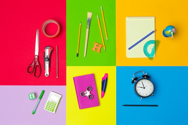 School supplies at colorful paper background