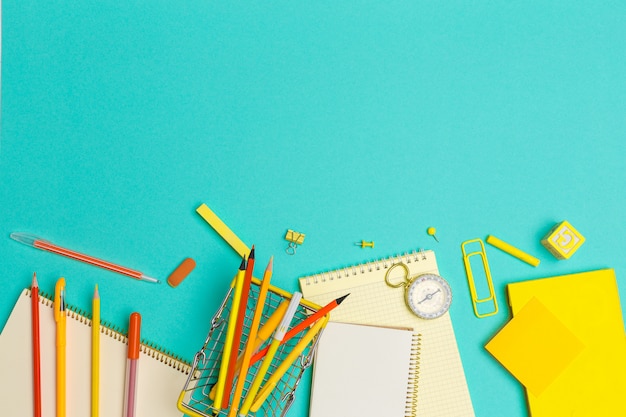 School supplies at colorful paper background