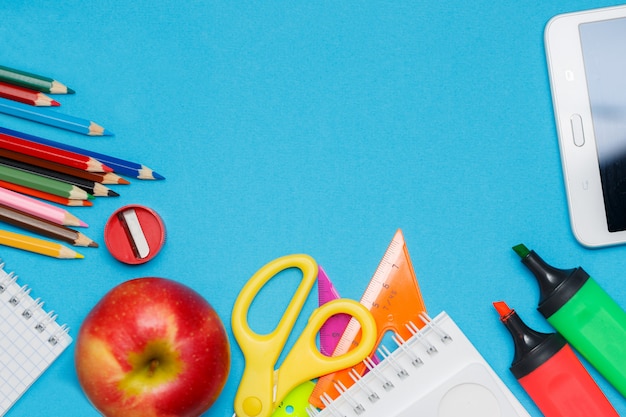 School supplies double border against a blue paper background