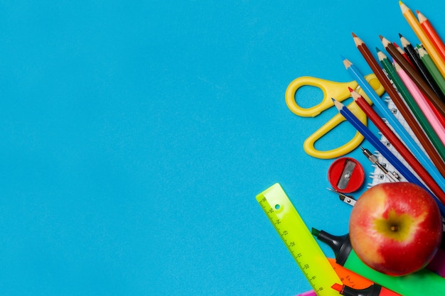 School supplies double border against a blue paper background