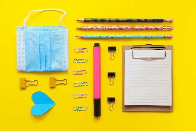 Photo school supplies flatlay on yellow