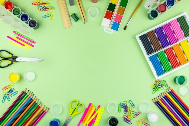 School supplies on a green background