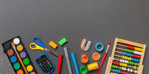 School supplies on grey background Education Back to School kids creativity concept