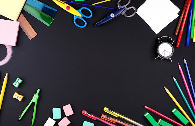 School supplies: multicolored wooden pencils, notebook, paper stickers, paper clips, pencil sharpener 