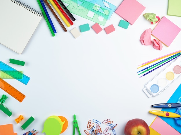 School supplies: multicolored wooden pencils, paper stickers, paper clips, pencil sharpener