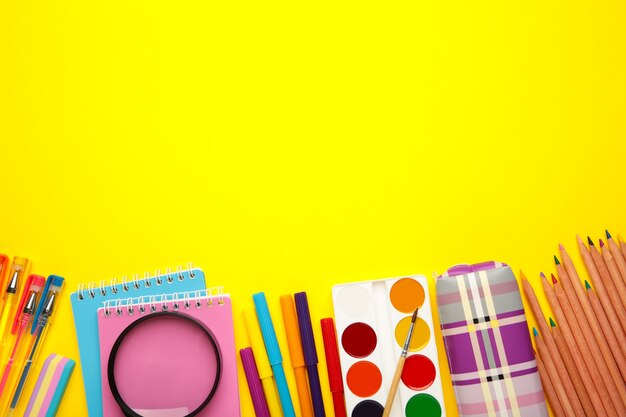 School supplies on pink background. Back to school concept.