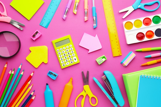 school supplies on pink with copy space.