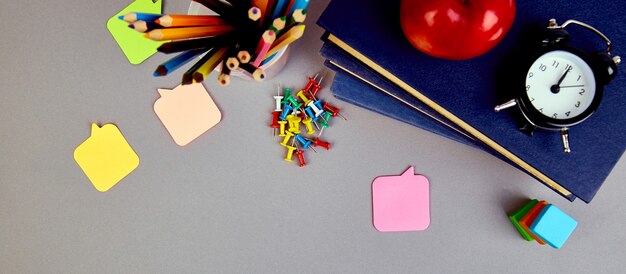 School supplies and a red apple