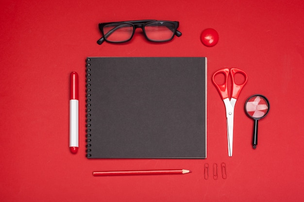 School supplies on red table top view