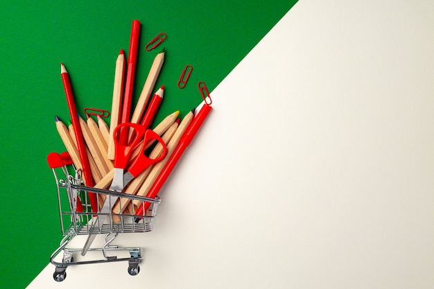 School supplies in a shopping cart, flat lay