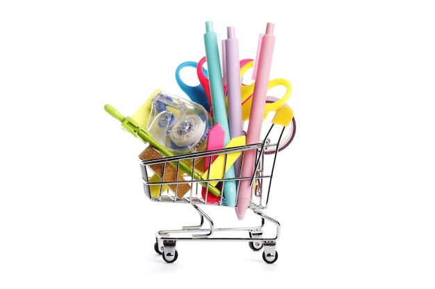 School supplies in shopping cart on white background