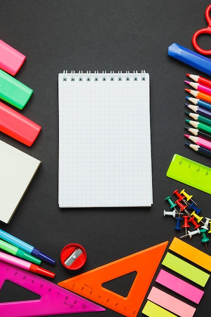 School supplies side border on a chalkboard background