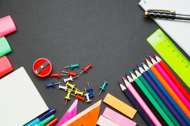 School supplies side border on a chalkboard background