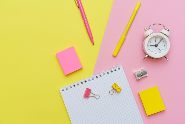 School supplies stationery on pink background Pens pencils notepad Flat lay