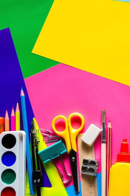 school supplies for study on a multicolored background with space for text
