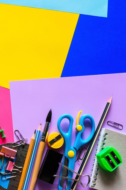 school supplies for study on a multicolored background with space for text