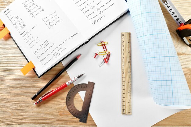 Photo school supplies and textbook on mathematics close up