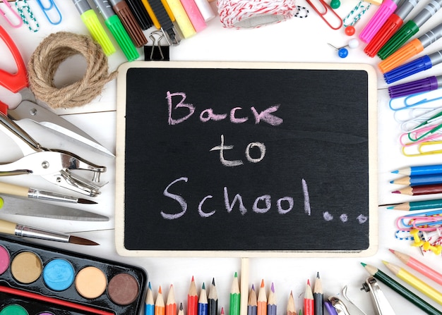 School supplies on white wooden background