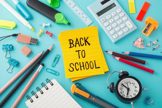 School supplies with Back to school message on sticky note