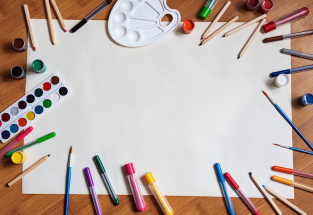 Photo school supplies on a wooden desk background