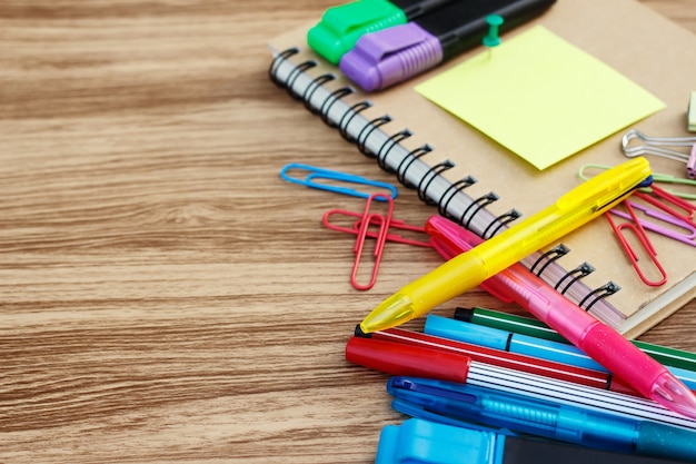 Photo school supplies on a wooden table with space for text