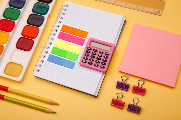 School supplies on yellow background. Back to school abstract image