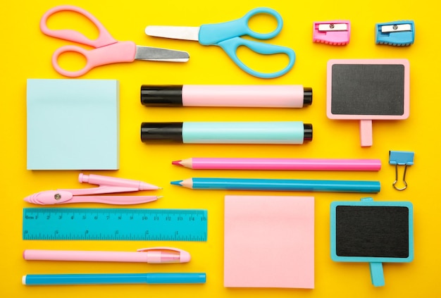 School supplies on yellow background back to school concept