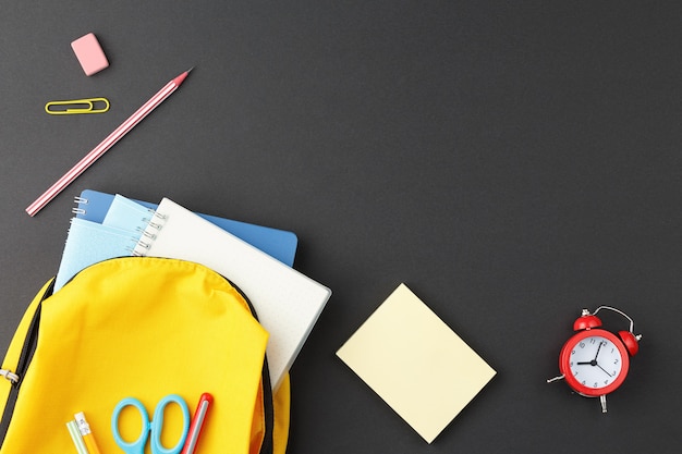 School supplies in a yellow backpack