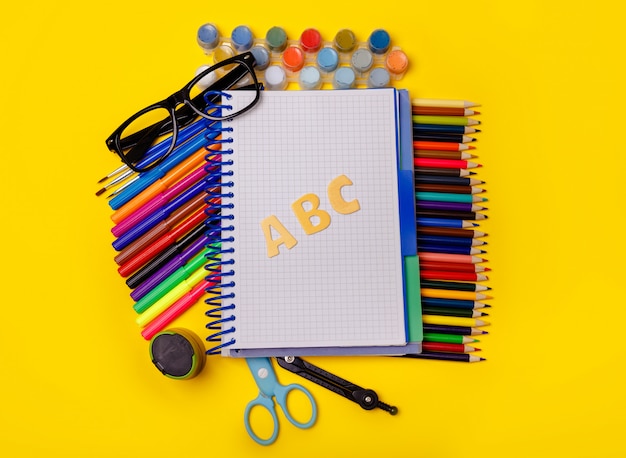 School supplies on yellow table. Back to school concept