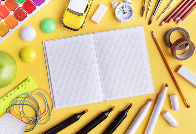 School supplies on yellow top view, flat lay