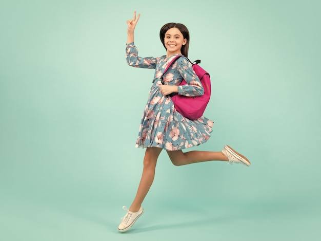 School teen girl in with backpack Run and jump Teenager student on isolated background Kids