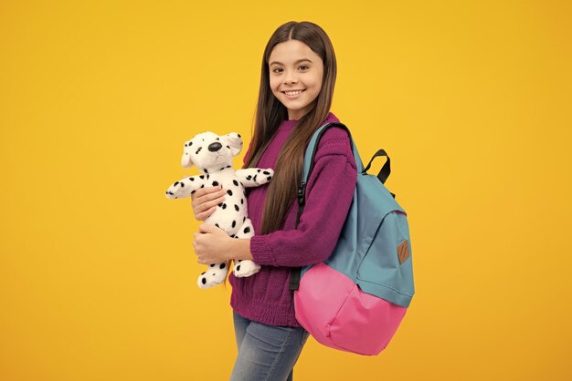 School teenager child girl with backpack hold toy fun study\
education and childhood concept