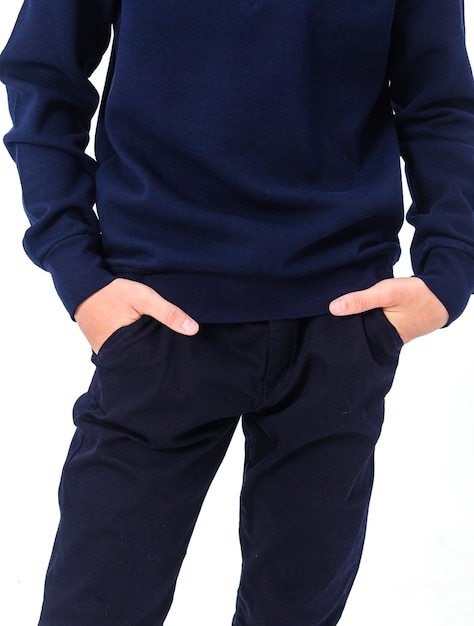 School uniform black trousers with pockets the boy keeps his hands in his pockets Vertical photo