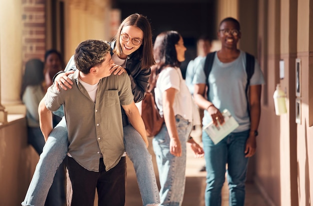 School university or funny students in college joke as happy friends on lunch break outside of a learning classroom Education piggy back or excited girl walking with a romantic boyfriend on campus