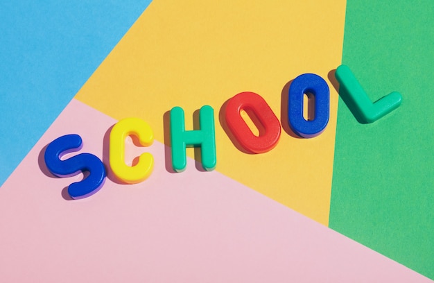 SCHOOL writing on a colorful pastel background.
